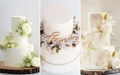 Trzy torty weselne w stylu boho: jeden z białymi różami i złotymi płatkami, drugi z napisem "love" i kwitnącą wiśnią, trzeci z koronkowym wzorem i suszonymi trawami.