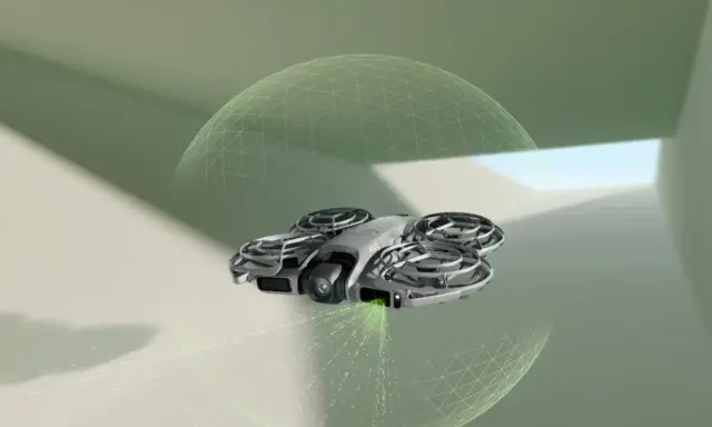 DJI NEO 2 Fly More Combo w locie, otoczony siatką bezpieczeństwa, emituje zielone światło.